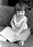 A young blind girl looks at a Braille page.